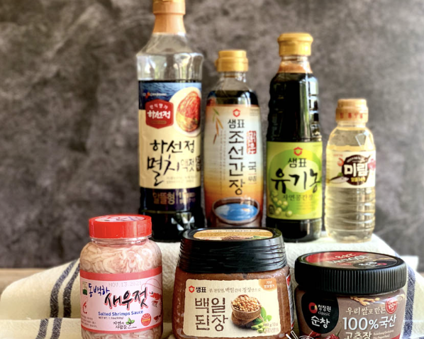 Korean pantry condiments: doenjang, gochujang, fish sauce, soy sauce, and related jars and bottles